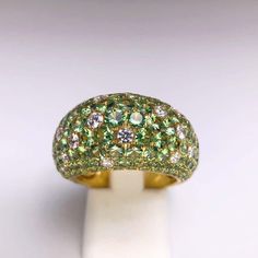 For Sale on 1stDibs - Crafted by the renowned Stenzhorn house of Jewellery, This classic 18kt yellow gold ring is pave' set with 8.20 carats of round green Tsavorite stones. Luxury Green Diamond Ring With Vvs Clarity, Luxury Green Diamond Ring With Brilliant Cut, Green Diamond Rings With Pave Setting, Luxury Green Round Cut Diamond Ring, Luxury Green Diamond Ring With Round Cut, Luxury Green Rings With Single Cut Diamonds, Luxury Green Dome Ring For Formal Occasions, Green Multi-stone Diamond Ring, Luxury Tsavorite Rings With Brilliant Cut