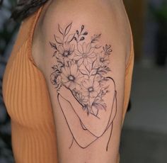 a woman's arm with flowers on it