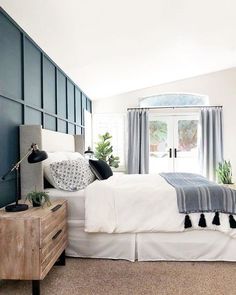 a bed room with a neatly made bed next to a dresser and a door leading to a patio