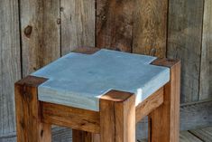 a small wooden stool sitting on top of a wooden floor