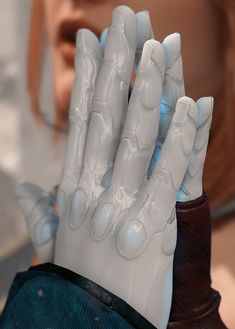 a close up of a person's hand with gloves on