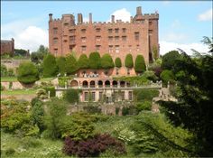 an old brick building surrounded by trees and bushes