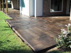 a wooden deck in front of a house