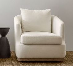 a white chair and side table in a room