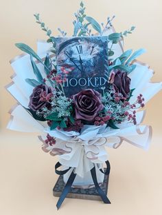 a bouquet of roses and greenery in front of a book titled hooked by the author