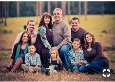 a family posing for a photo in the grass