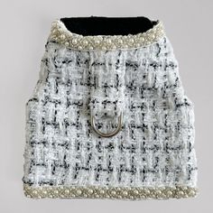 a white and black purse with pearls on it