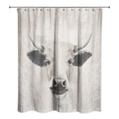 a shower curtain with an image of a cow's head