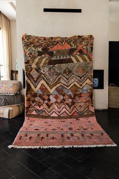 a large multicolored rug is on the floor