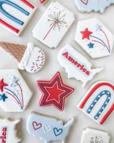 decorated cookies are arranged on a white surface