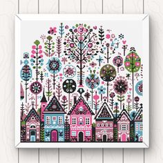 a cross stitch pattern with houses and trees