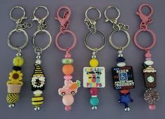 six different key chains with various designs and colors are shown in this photo, one is for the camera