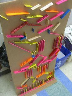 a cardboard board with many different colored toothbrushes on it