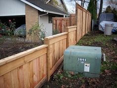 a mailbox sitting next to a wooden fence