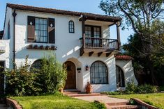 a white house with brown shutters and windows