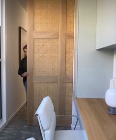 a woman standing in front of a wooden door