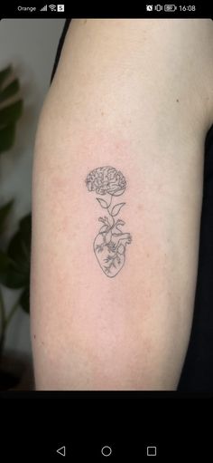 a woman's arm with a flower tattoo on the left side of her body