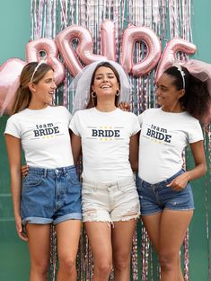 three women standing next to each other wearing t - shirts with wine glasses on them