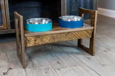 two bowls are sitting on a bench with the word cool written on it in front of a fireplace