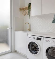 a washer and dryer in a white laundry room