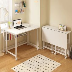 a laptop computer sitting on top of a white desk next to a book shelf and lamp