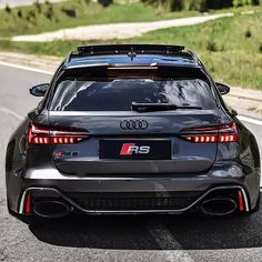 an audi rs parked on the side of the road with its rear lights turned off