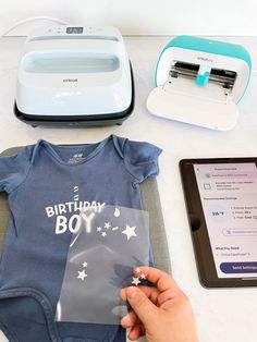 a baby's first birthday gift set up on a table next to an ipad