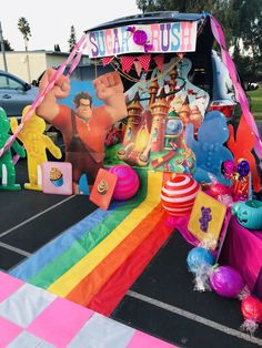 an inflatable toy car is decorated with balloons and decorations