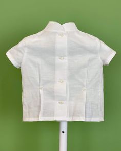 An elegant two-piece set for baby boys to wear during any special occasion. The top has a mao, or Chinese, collar, two crochet lace on the front, handmade pleats, and short sleeves; it has buttons on the back for closure. The bottom are bubble shorts with a sash of three pleats, it has buttons on the sides for closure and an elastic band on the back. The interior, or lining, is made with cotton fabric, while the exterior is with off-white linen. Dry clean 3 piece set Interior: 100% cotton; exter Classic White Collared Sets, Elegant Short Sleeve Baptism Sets, Classic Fitted Short Sleeve Sets, Classic Short Sleeve Sets For Baptism, Bubble Clothes, Boy Baptism Outfit, Baptism Outfit, Boy Baptism, White Linen