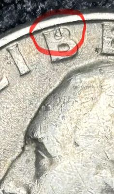 a close up of a coin with a red circle on it