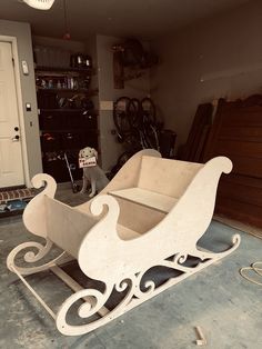 a wooden sleigh sitting on top of a floor