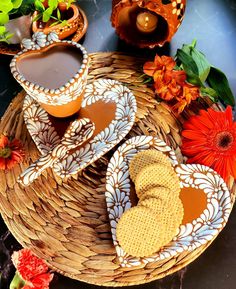 two plates with cookies on them next to some flowers