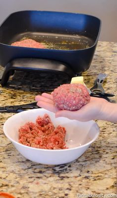 a person is scooping ground meat into a bowl