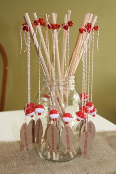 a jar filled with candy canes on top of a table