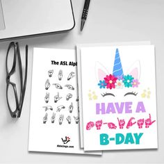 an open notebook with the words have a b - day on it next to a pair of glasses