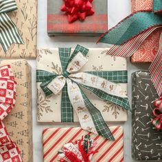 wrapped presents with bows and ribbons on them