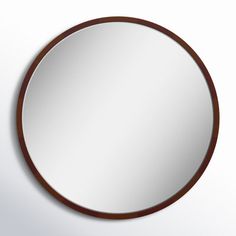 a round mirror hanging on the wall