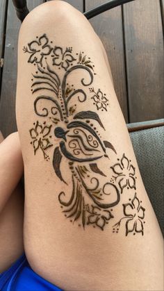 a woman's legs with a tattoo on it