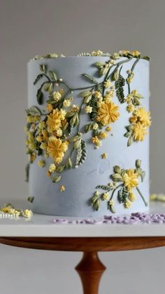 a blue cake with yellow flowers on it