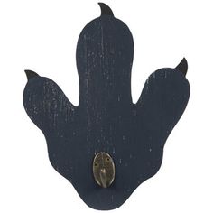 a black metal object with a bird on it's back and an oval hole in the middle