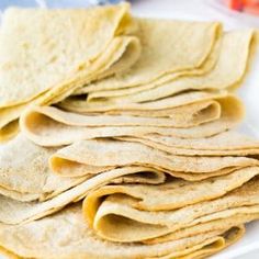 a white plate topped with tortillas and strawberries