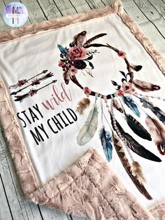 a blanket with an embroidered dream catcher on it that says stay wild, my child