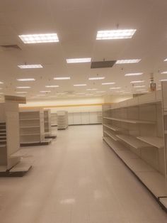 empty shelves in the middle of a large room with no one inside or outside them