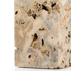 a stone block with holes in it on a white background