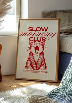 a framed poster sitting on top of a wooden floor next to a guitar and pillow