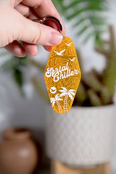 a person holding up a yellow and white keychain with the words grateful written on it