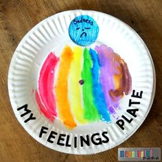 a paper plate with a drawing of a rainbow on it that says, my feelings please