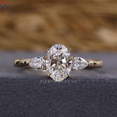 a three stone ring with pear shaped diamonds