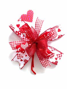 a red and white bow with hearts on it