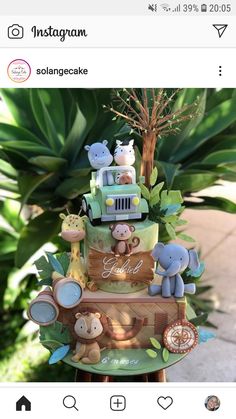 the cake is decorated with animals and trees